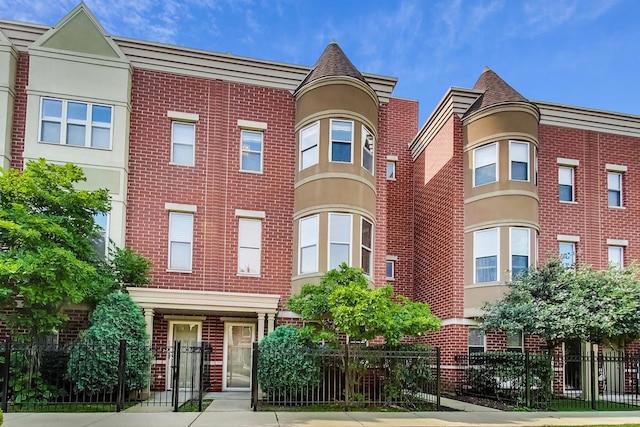 view of front of property with fence and brick siding