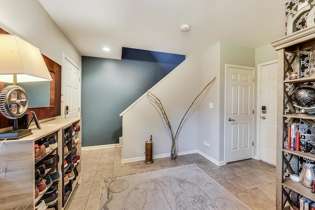 interior space featuring light tile patterned flooring, recessed lighting, and baseboards