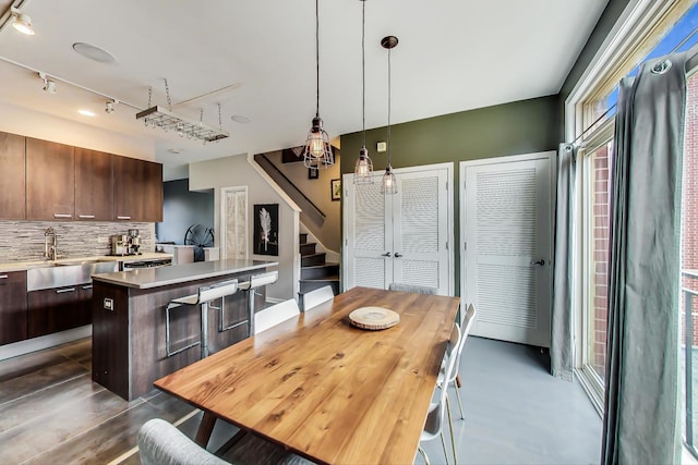 dining area featuring stairway