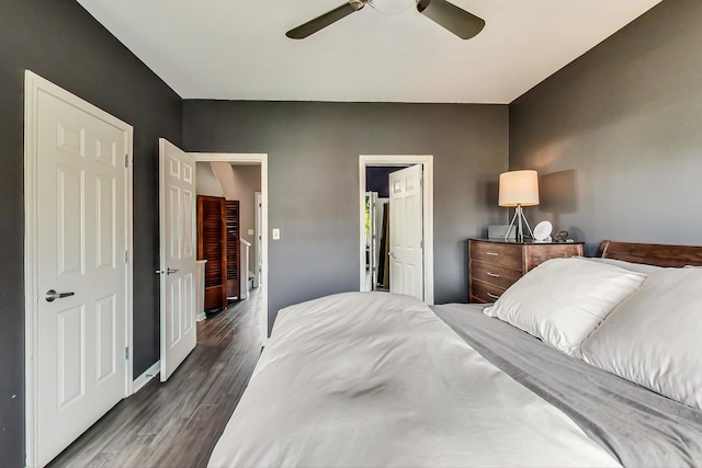 bedroom featuring dark wood finished floors, baseboards, and a ceiling fan