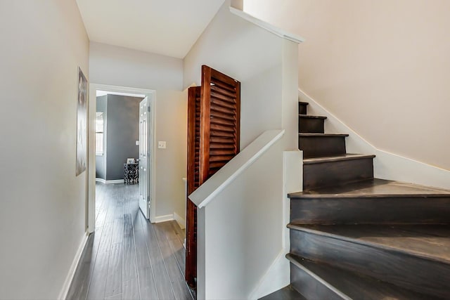 stairs featuring baseboards and wood finished floors