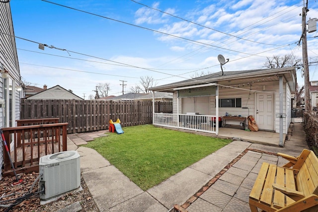 view of yard with cooling unit, a patio, and fence