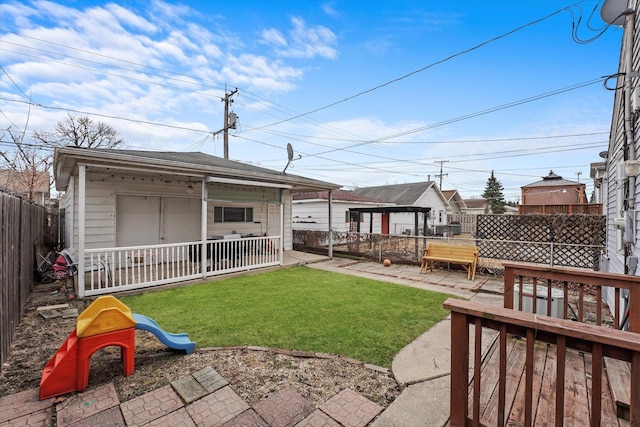 view of yard featuring a patio area, a fenced backyard, and an outbuilding