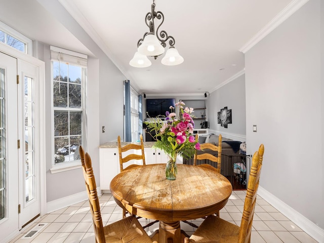 dining room featuring a wealth of natural light, crown molding, baseboards, and light tile patterned floors