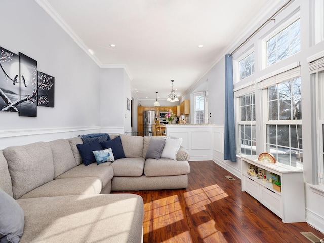 living room with ornamental molding, dark wood-style flooring, visible vents, and recessed lighting