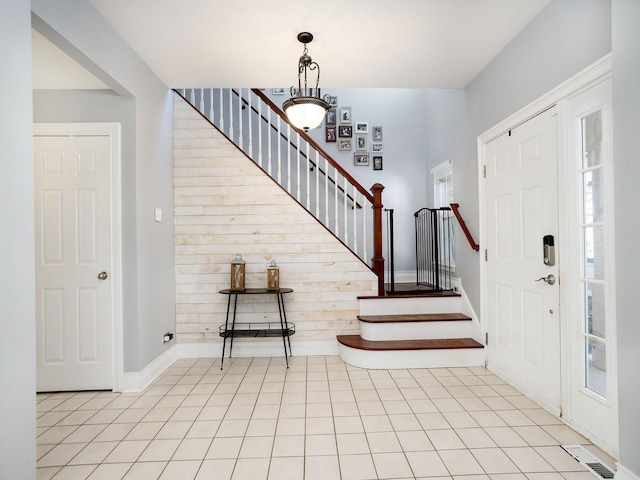 entrance foyer featuring visible vents, stairway, baseboards, and light tile patterned floors