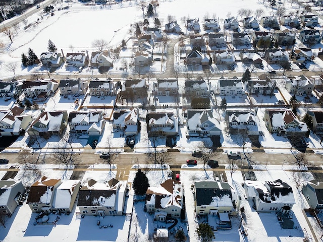 snowy aerial view featuring a residential view