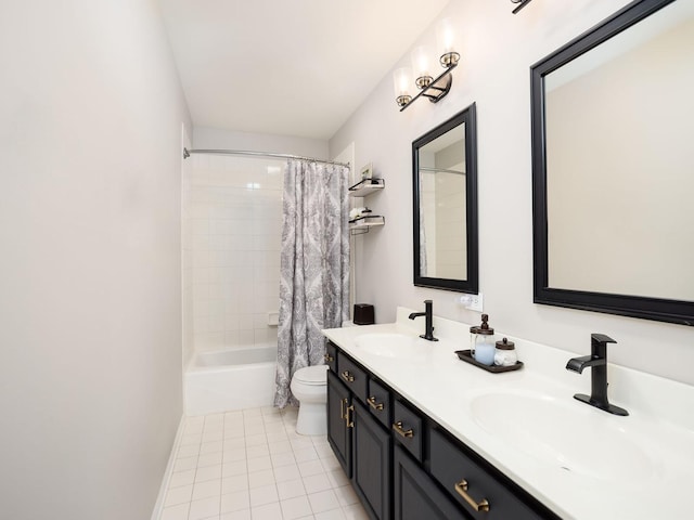 bathroom featuring tile patterned floors, a sink, toilet, and double vanity