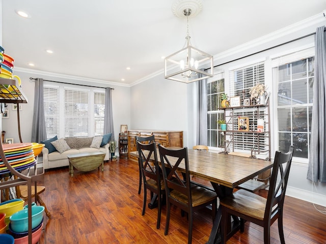 dining area with a notable chandelier, recessed lighting, wood finished floors, and crown molding