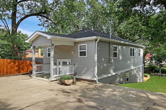 exterior space featuring a patio area, fence, and a lawn