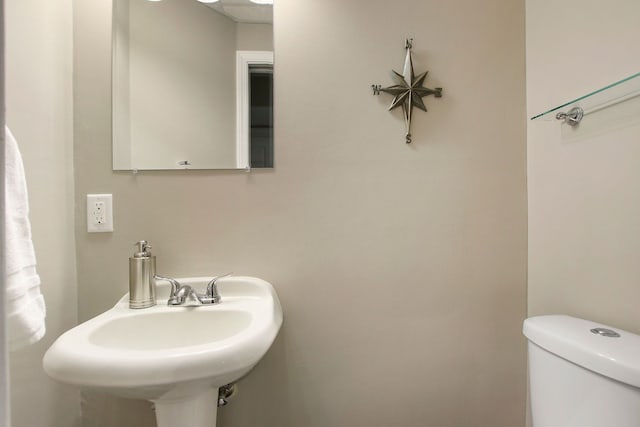 bathroom featuring toilet and a sink