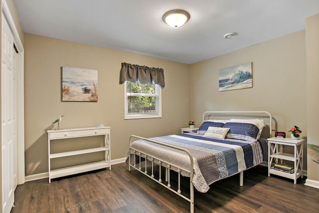 bedroom with baseboards and wood finished floors