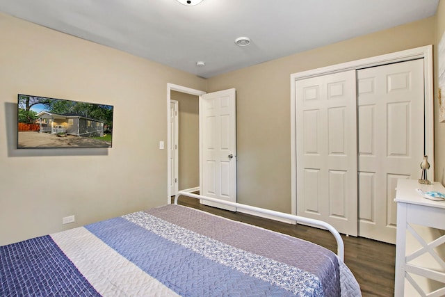 bedroom with a closet and dark wood-type flooring