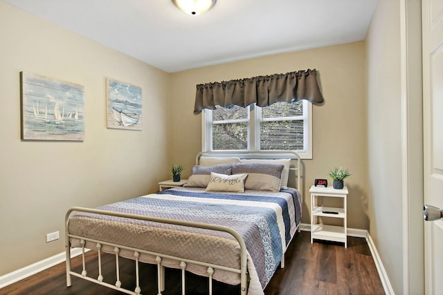 bedroom with dark wood finished floors and baseboards