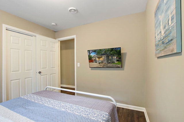 bedroom featuring baseboards and wood finished floors