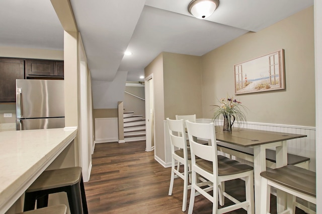 dining room featuring stairs, dark wood-type flooring, and recessed lighting