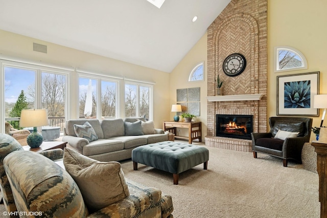 carpeted living area with high vaulted ceiling, a fireplace, and visible vents