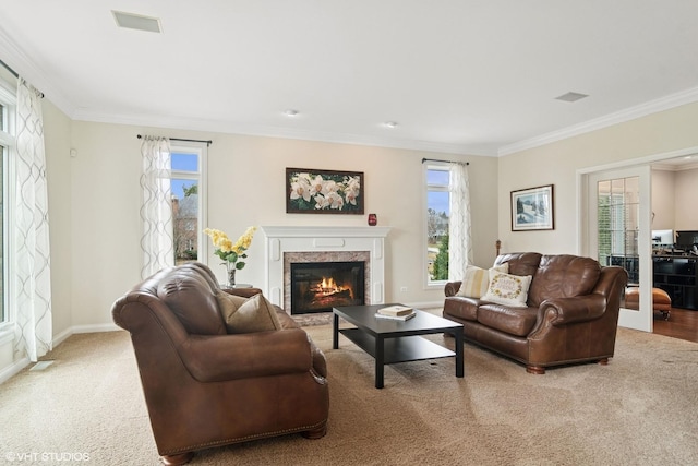 carpeted living area with a fireplace, visible vents, ornamental molding, and baseboards