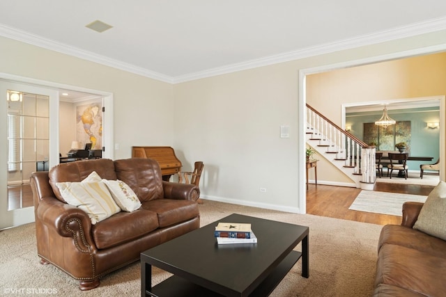 living room featuring baseboards, crown molding, wood finished floors, and stairway
