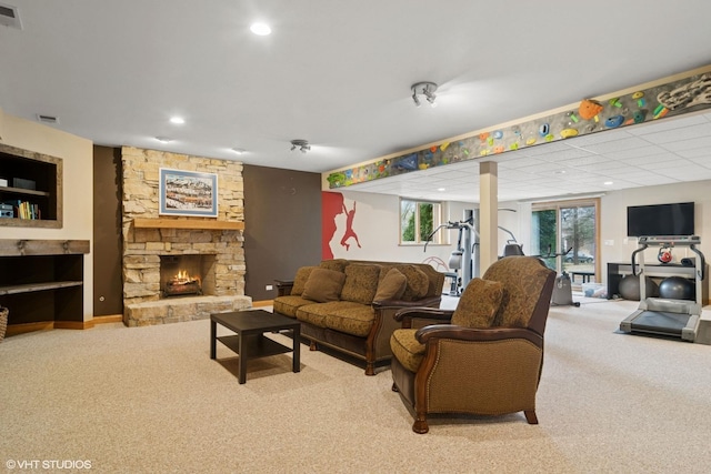 living room with carpet floors, a fireplace, and visible vents
