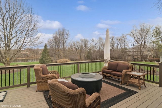 deck featuring outdoor lounge area and a lawn