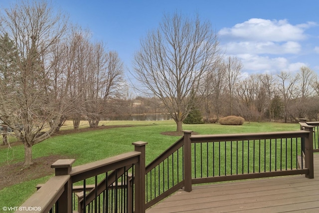 wooden deck with a water view and a yard