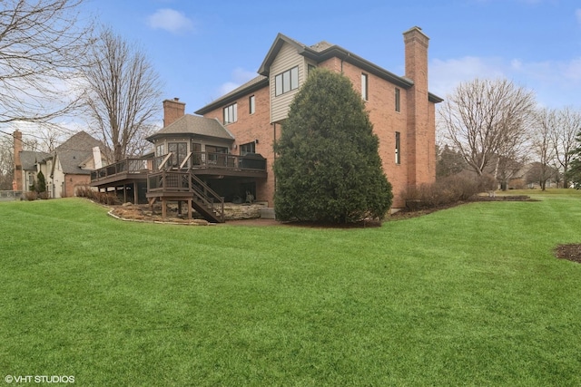 back of house featuring a wooden deck, a yard, stairs, and a chimney