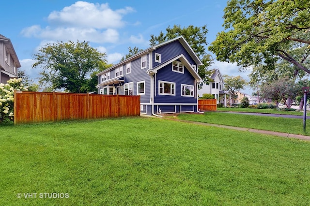 back of property featuring a yard and fence