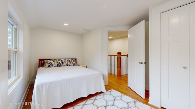 bedroom with wood finished floors and recessed lighting