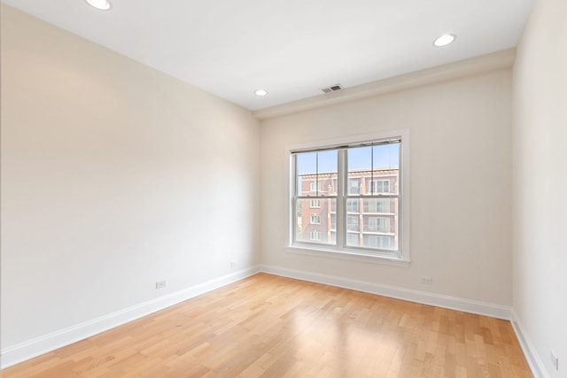 spare room with baseboards, recessed lighting, visible vents, and light wood-style floors