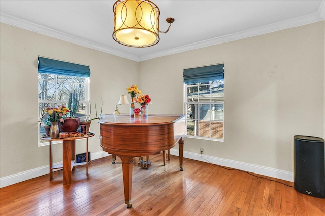 living area featuring plenty of natural light, crown molding, and wood-type flooring