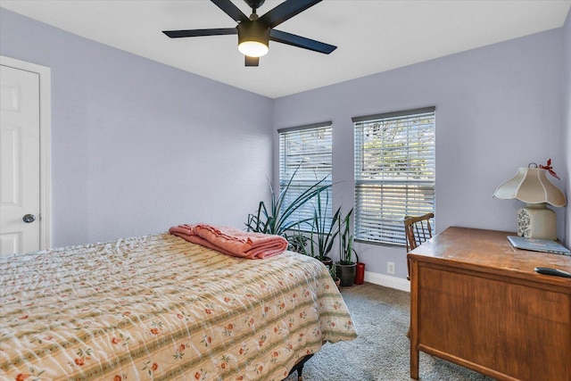 carpeted bedroom featuring baseboards and ceiling fan