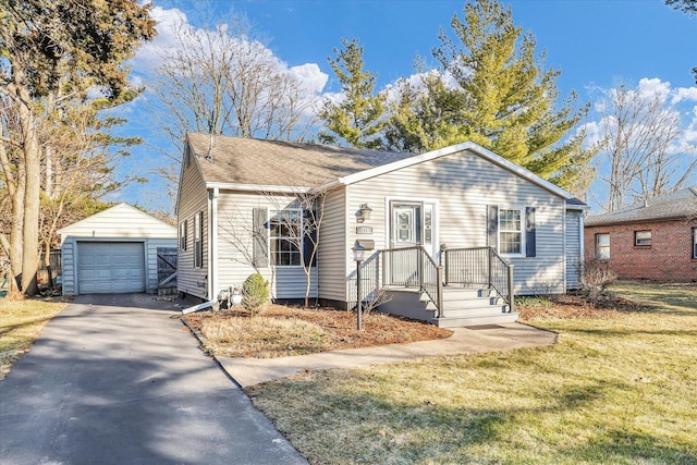 view of front of property featuring an outbuilding, aphalt driveway, a shingled roof, a front lawn, and a detached garage