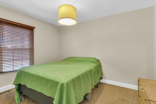 bedroom featuring baseboards and light colored carpet