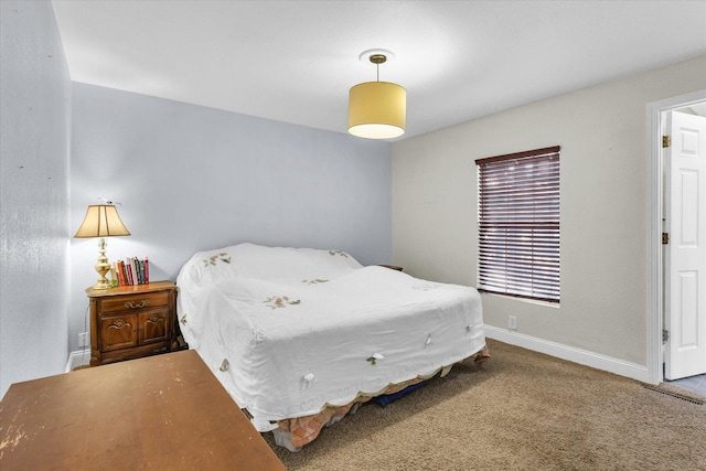 bedroom featuring baseboards and carpet