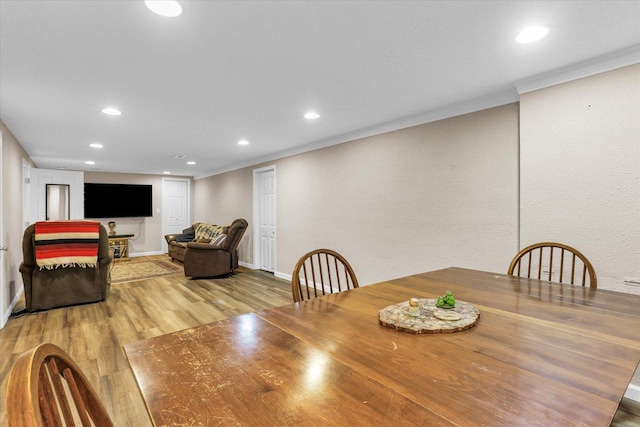 dining room featuring crown molding, recessed lighting, and wood finished floors