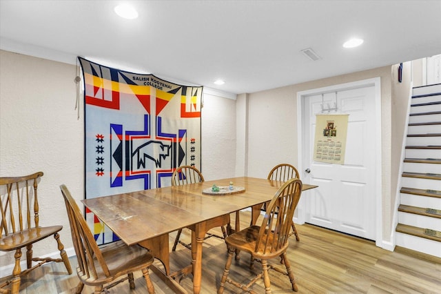 dining area featuring light wood finished floors, stairway, recessed lighting, and baseboards