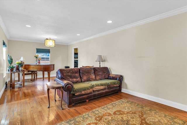 living room featuring baseboards, wood-type flooring, and ornamental molding