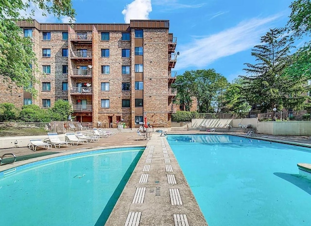 pool with fence and a patio