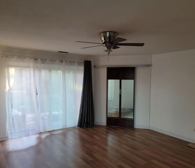 spare room with ceiling fan and wood finished floors