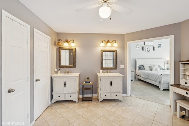 ensuite bathroom with ensuite bath, tile patterned flooring, two vanities, and a sink