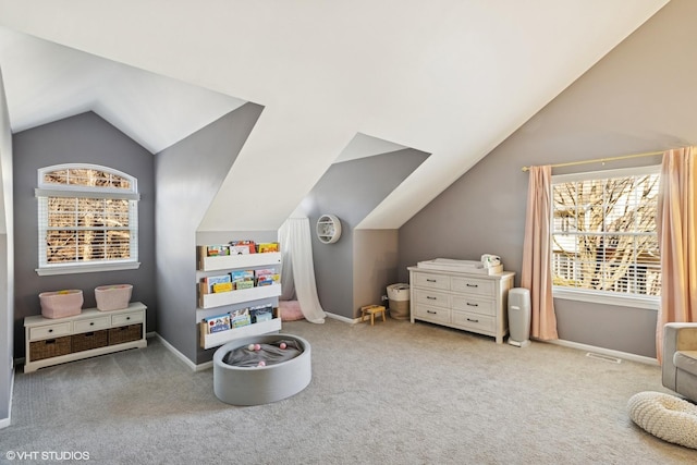 recreation room featuring carpet, baseboards, and vaulted ceiling