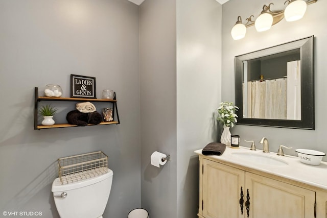 full bathroom featuring vanity and toilet