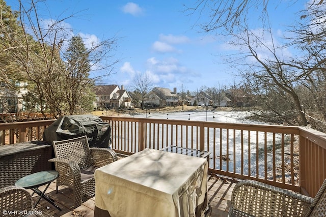 deck with a residential view and grilling area