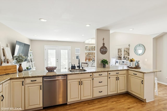 kitchen featuring a sink, cream cabinetry, and stainless steel dishwasher