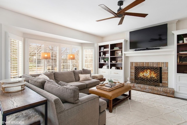 living room featuring a fireplace and a ceiling fan