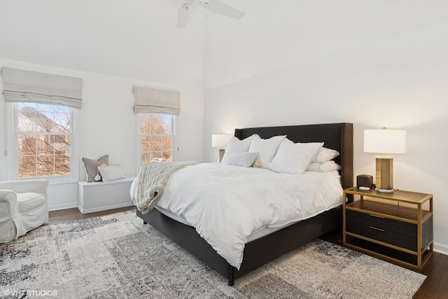 bedroom with ceiling fan, baseboards, and wood finished floors