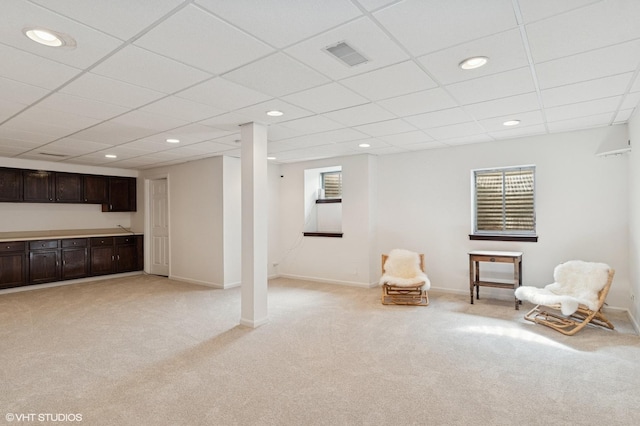 unfurnished room with visible vents, baseboards, and light colored carpet