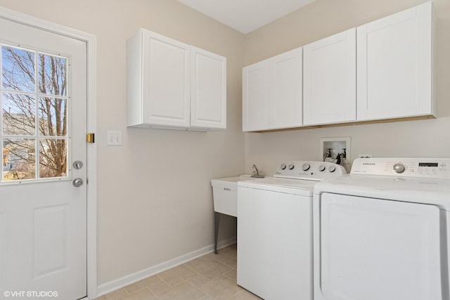 laundry room with baseboards, cabinet space, and washing machine and dryer