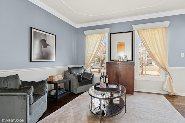 living room featuring a wealth of natural light, ornamental molding, baseboards, and wood finished floors